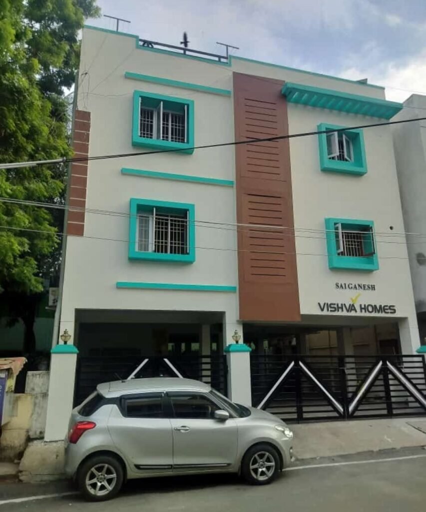 Apartment exterior repaint in white and teal by Evolve Decors, Chennai
