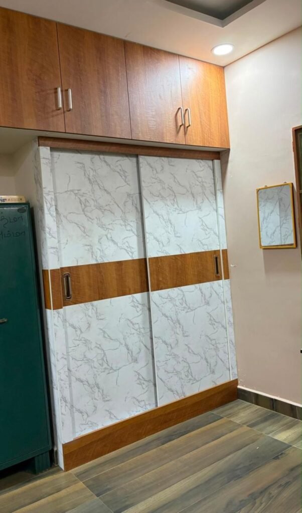 Marble-finish sliding wardrobe by Evolve Decors, Chennai